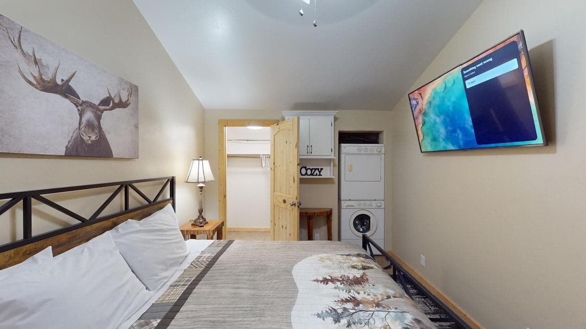 Relax after a long day in this bedroom that brings a mix of modern amenities with a rustic feel.