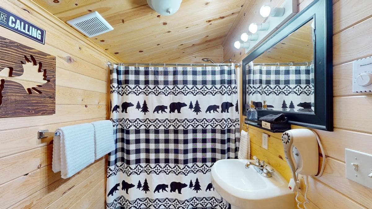 Full size bathroom with a shower tub combo, toilet, and sink.